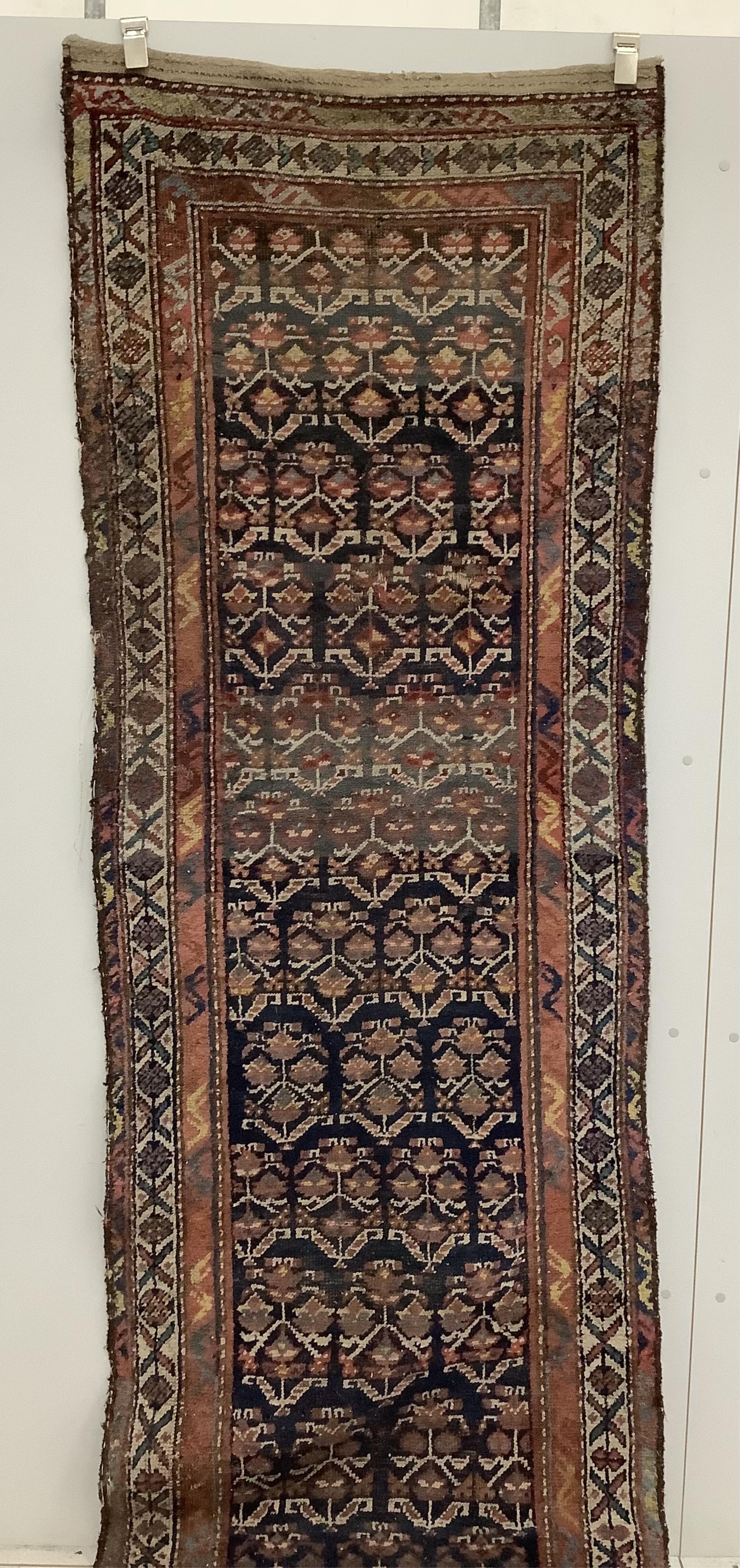 An antique Caucasian blue ground runner, approximately 500 x 91cm. Condition - poor